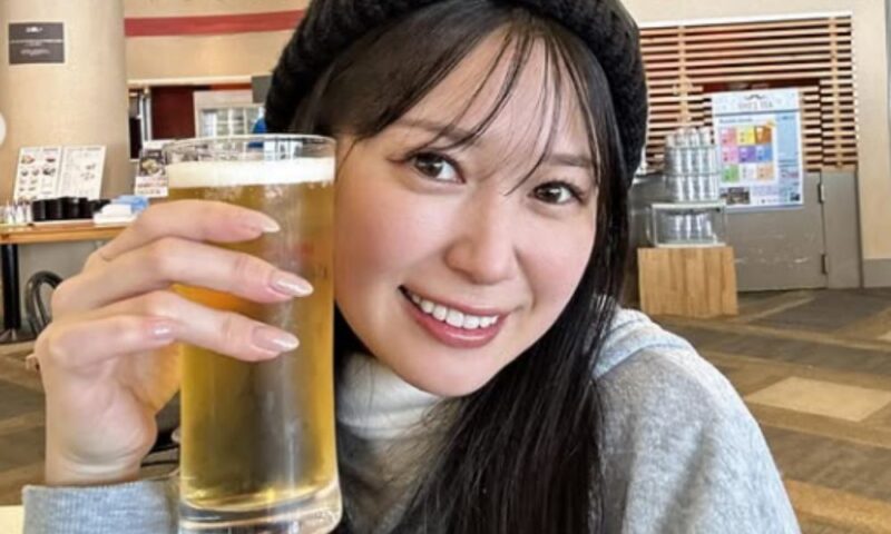 スノーボード後に食事を楽しみながらビールを手に笑顔を見せる荒井つかさ